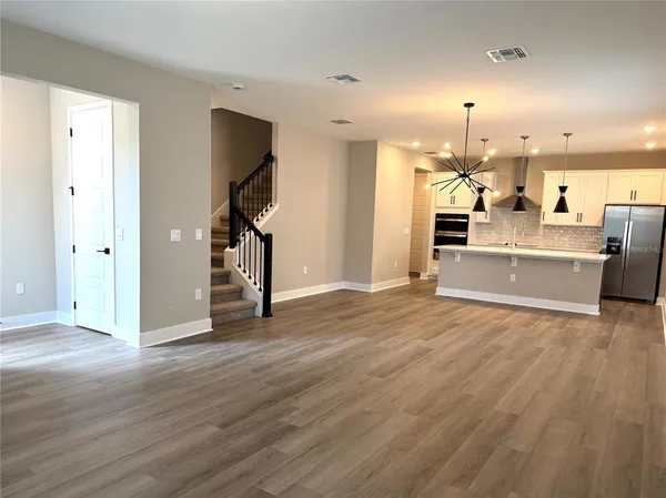 a view of a kitchen with wooden floor