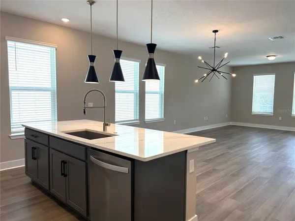 a kitchen with sink cabinets and wooden floor