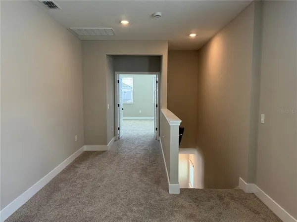 an entryway in a hall with a window