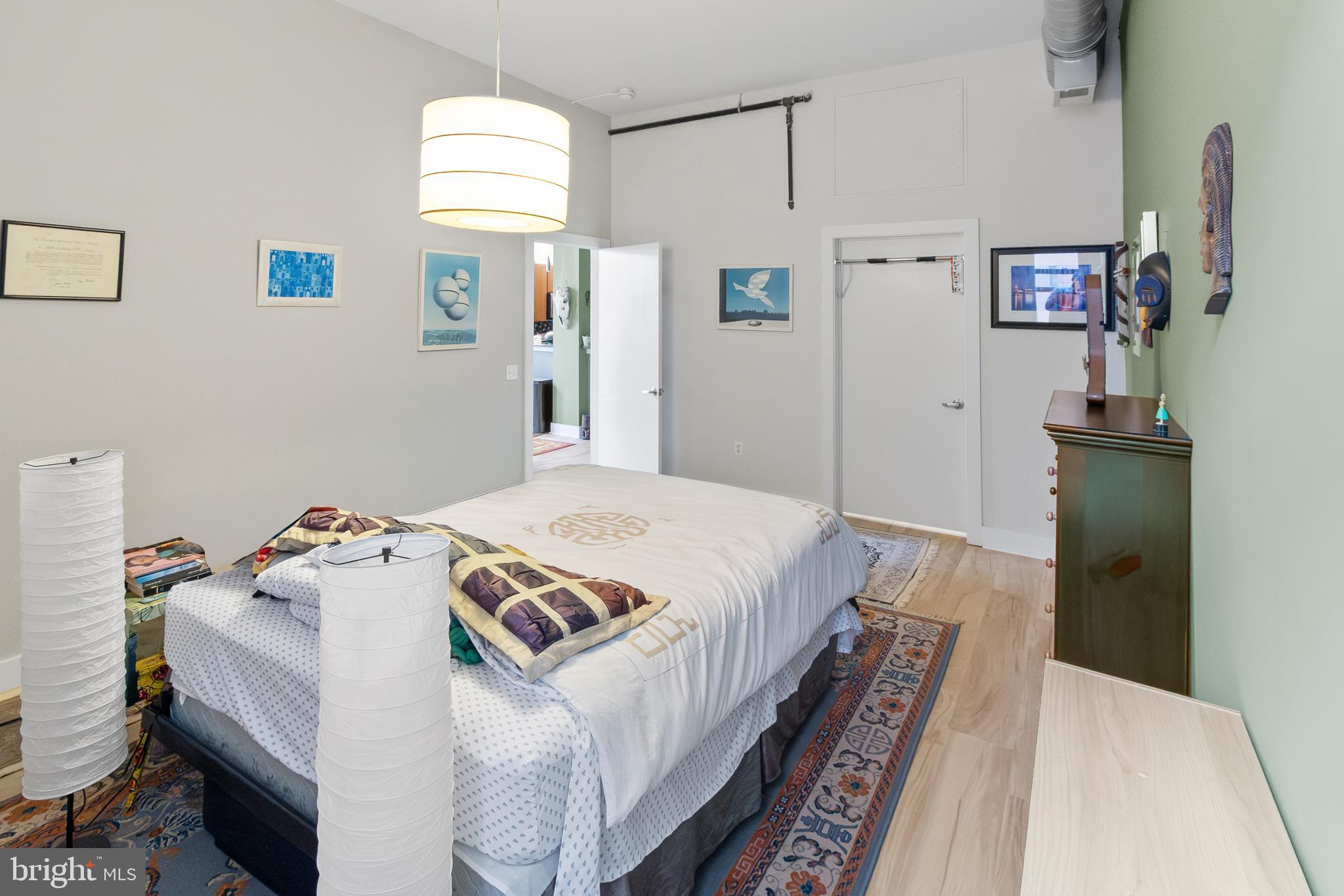 22 South Howard Street, Unit R503 Baltimore, MD 21201 - Photo 15 of 29 a bedroom with bed and wooden floor