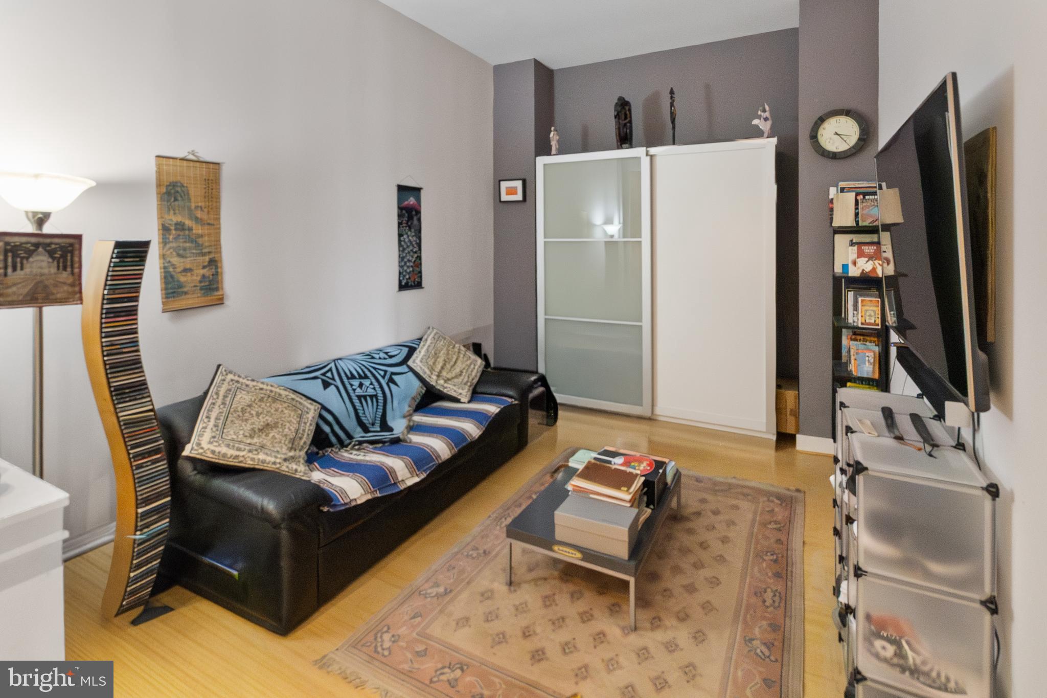 22 South Howard Street, Unit R503 Baltimore, MD 21201 - Photo 19 of 29 a living room with furniture and a flat screen tv