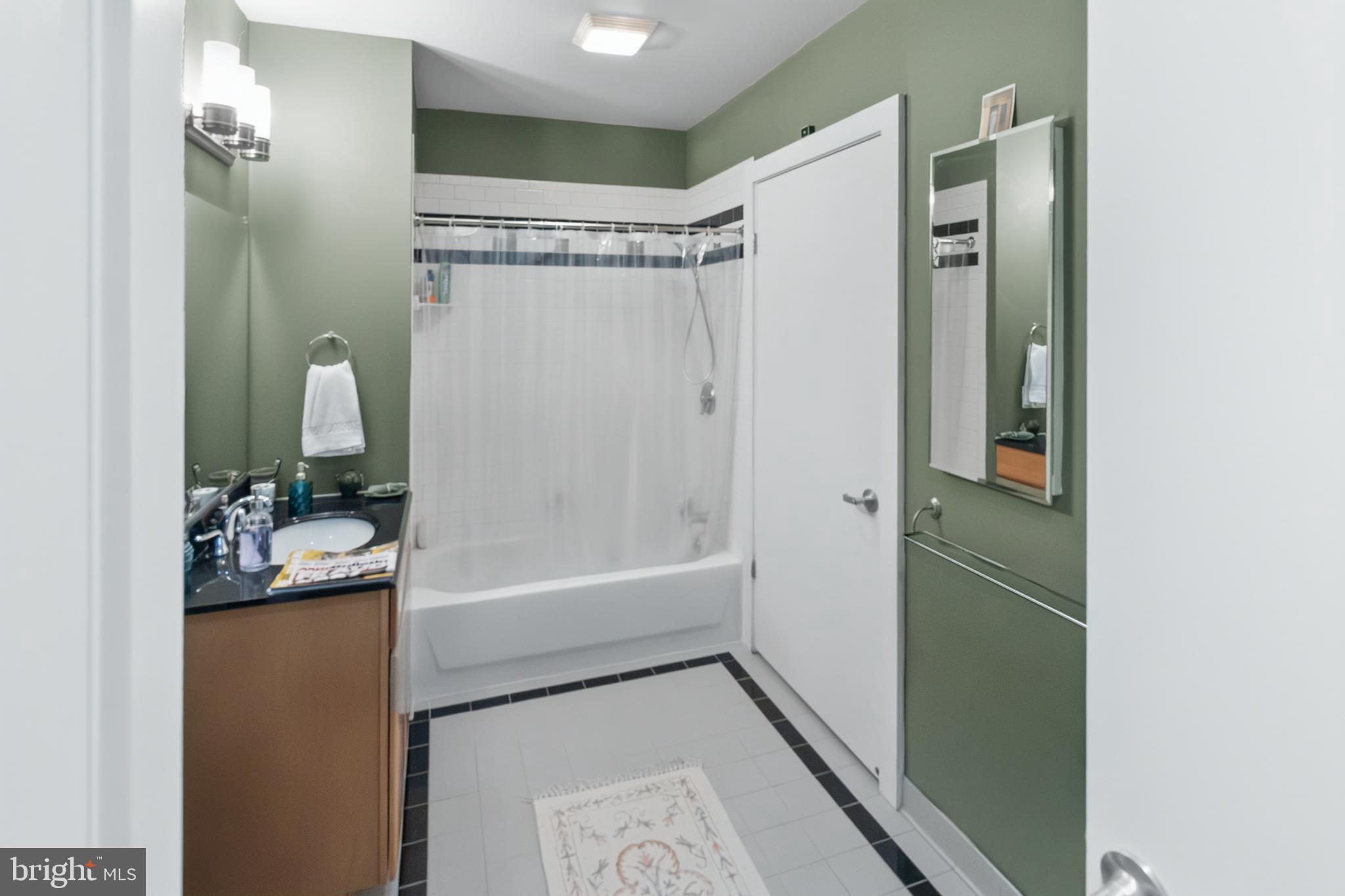 22 South Howard Street, Unit R503 Baltimore, MD 21201 - Photo 22 of 29 a bathroom with a bathtub a toilet and a shower