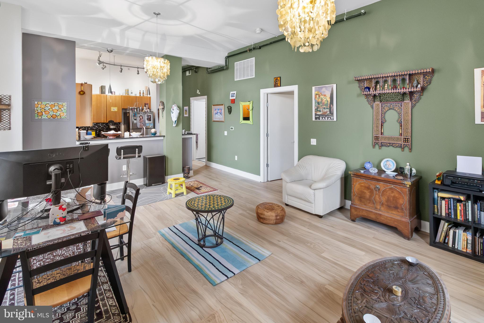 22 South Howard Street, Unit R503 Baltimore, MD 21201 - Photo 5 of 29 a living room with furniture and a chandelier