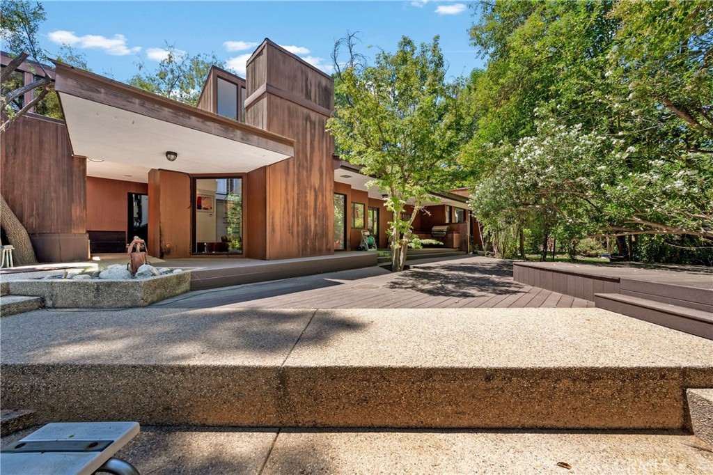24865 Long Valley Road Hidden Hills, CA 91302 - Photo 1 of 49 a front view of a house with a yard and garage