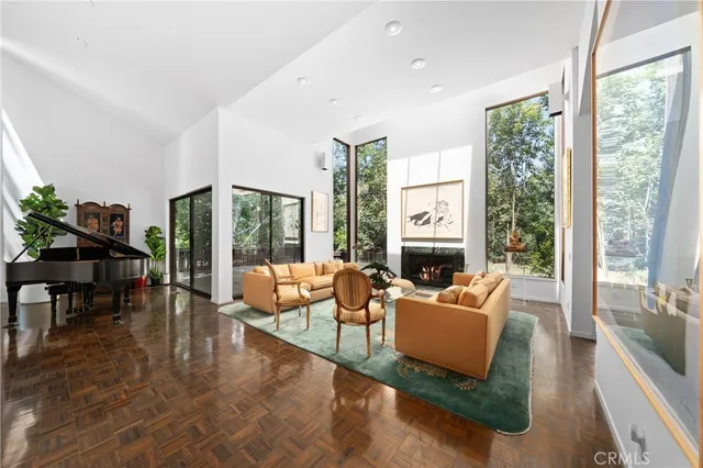 a living room with fireplace furniture and a large window