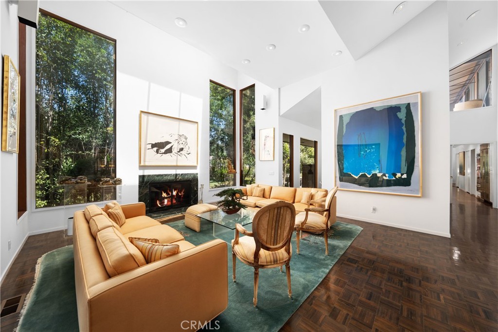 24865 Long Valley Road Hidden Hills, CA 91302 - Photo 12 of 49 a living room with fireplace furniture and a large window