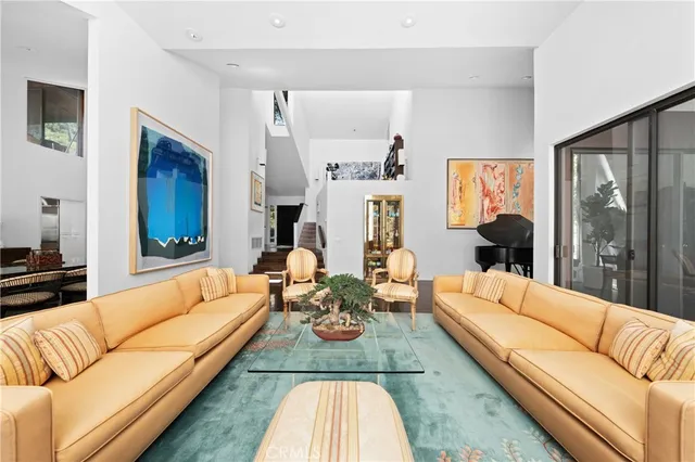 a living room with furniture and a painting on the wall