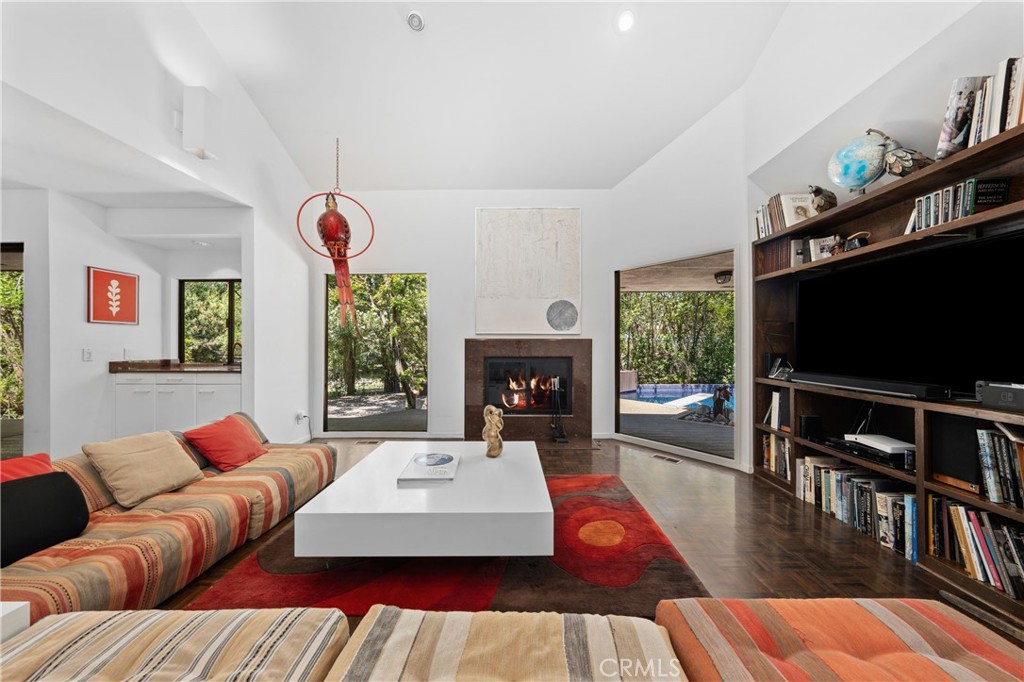 24865 Long Valley Road Hidden Hills, CA 91302 - Photo 19 of 49 a living room with furniture a flat screen tv and a fireplace