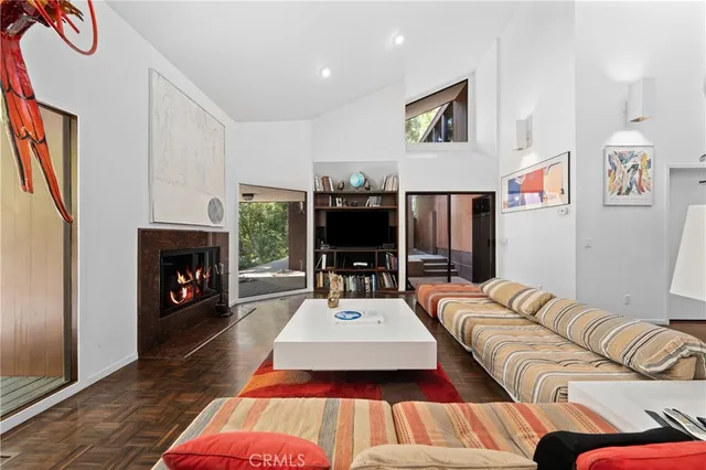 a dining room with furniture and a floor to ceiling window