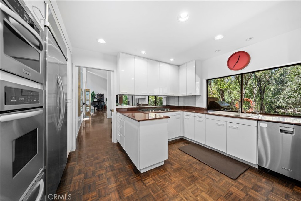 24865 Long Valley Road Hidden Hills, CA 91302 - Photo 24 of 49 a kitchen with granite countertop white cabinets and stainless steel appliances
