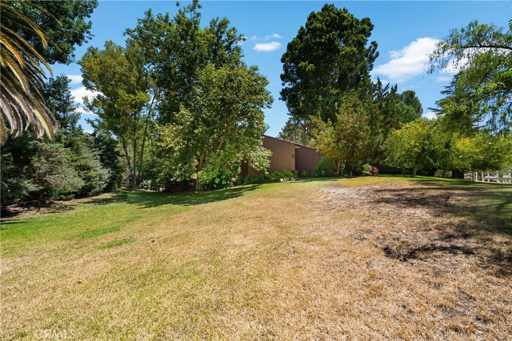 24865 Long Valley Road Hidden Hills, CA 91302 - Photo 28 of 49 a backyard of a house with lots of green space