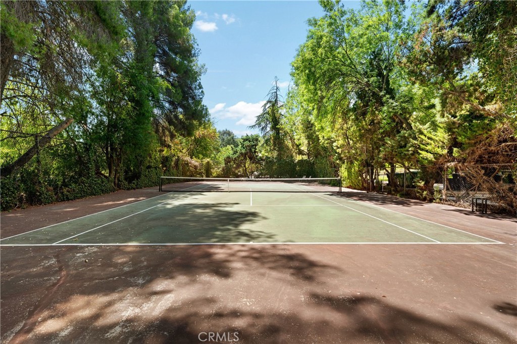 24865 Long Valley Road Hidden Hills, CA 91302 - Photo 30 of 49 a view of a tennis ground with large trees