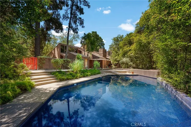 a view of swimming pool with outdoor seating and plants