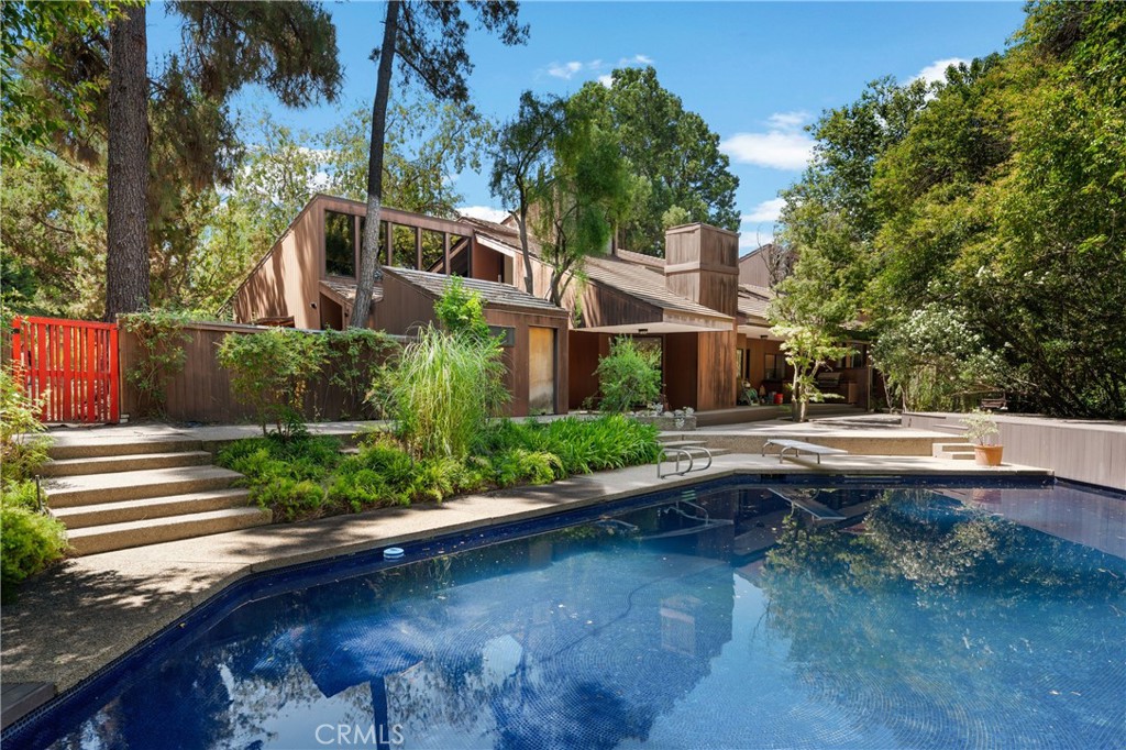 24865 Long Valley Road Hidden Hills, CA 91302 - Photo 32 of 49 a view of swimming pool with outdoor seating and plants