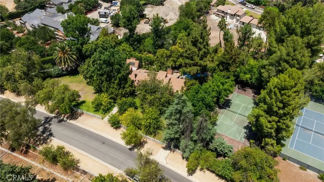 an aerial view of a houses with yard