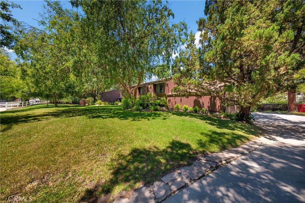 24865 Long Valley Road Hidden Hills, CA 91302 - Photo 5 of 49 a view of a swimming pool with a garden