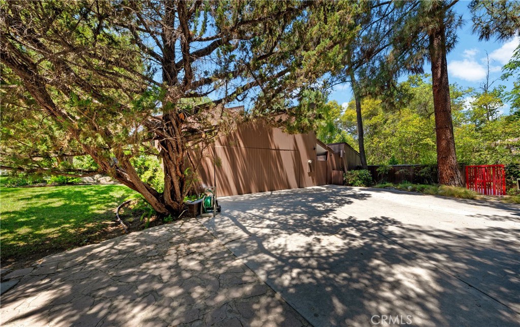 24865 Long Valley Road Hidden Hills, CA 91302 - Photo 8 of 49 a backyard of a house with a table and trees