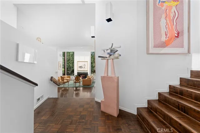 a living room with fireplace furniture and a large window