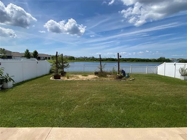 a view of a garden with wooden fence