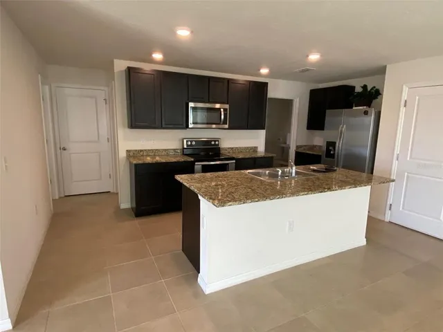 a view of a kitchen with granite countertop and sink