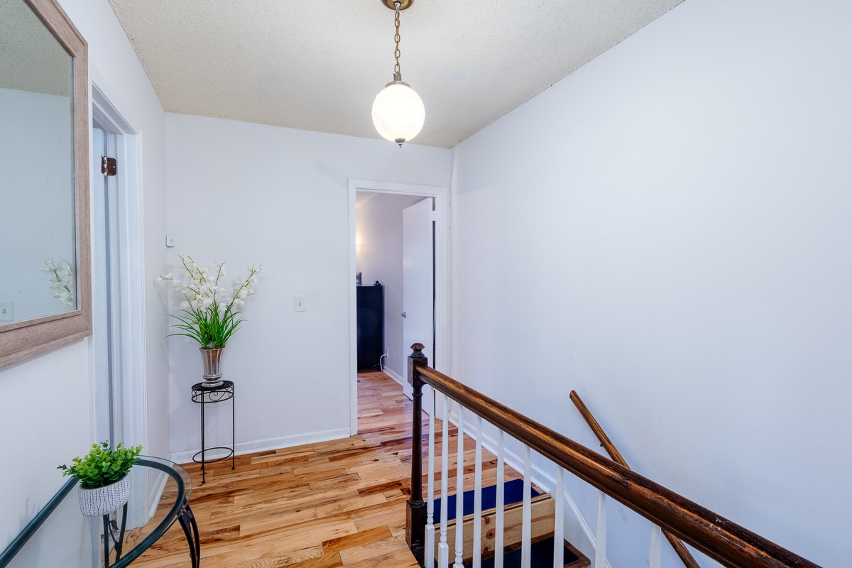 4000 Anderson Road, Unit 82 Nashville, TN 37217 - Photo 18 of 30 a view of a hallway with wooden floor and a chandelier