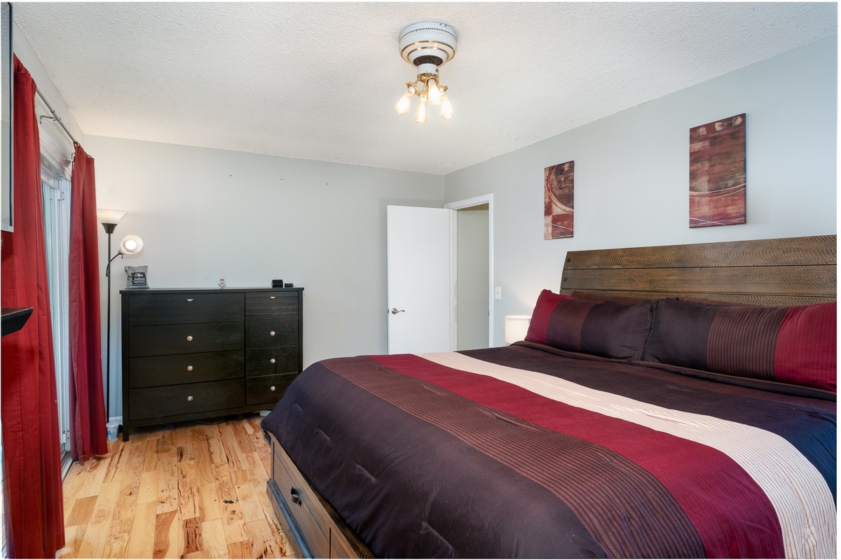 4000 Anderson Road, Unit 82 Nashville, TN 37217 - Photo 22 of 30 a bedroom with a bed and a chandelier