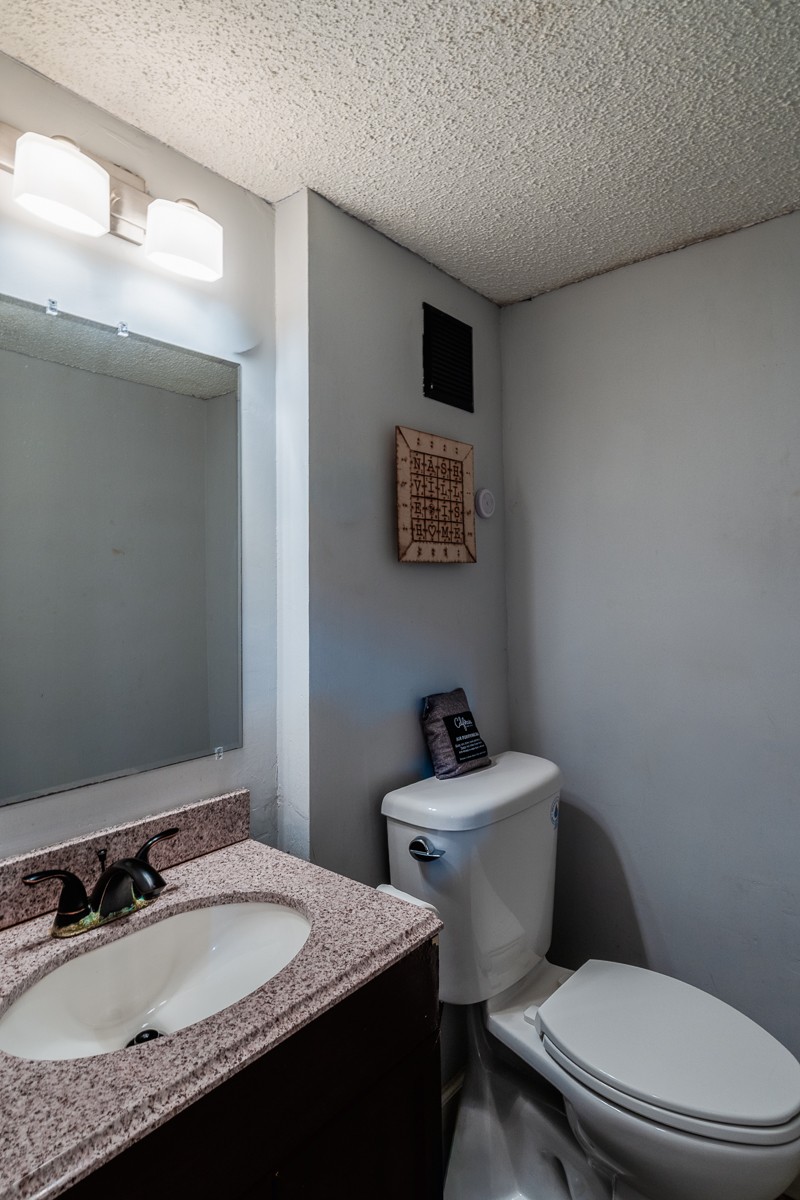 4000 Anderson Road, Unit 82 Nashville, TN 37217 - Photo 7 of 30 a bathroom with a granite countertop toilet sink and mirror