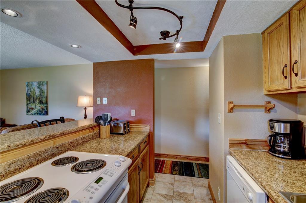 520 Bills Ranch Road, Unit 173 Frisco, CO 80443 - Photo 12 of 24 a kitchen with kitchen island a sink stove and refrigerator