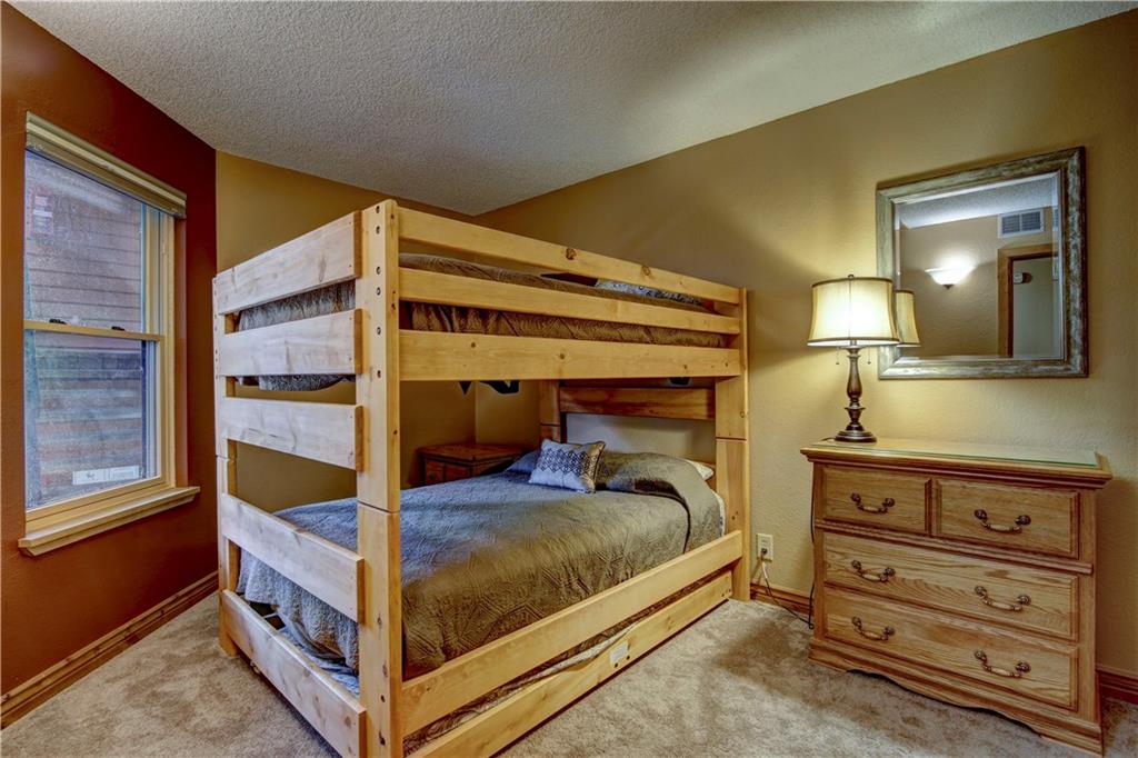 520 Bills Ranch Road, Unit 173 Frisco, CO 80443 - Photo 14 of 24 a bedroom with a bed and a mirror on the dresser