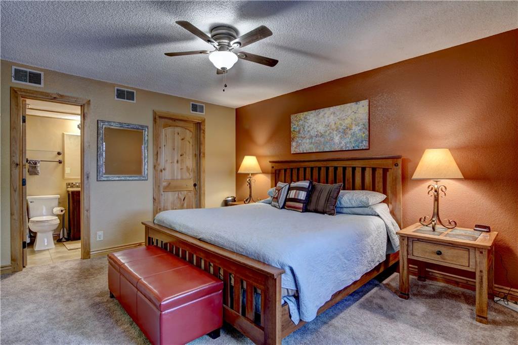 520 Bills Ranch Road, Unit 173 Frisco, CO 80443 - Photo 16 of 24 a bedroom with a bed and a chandelier