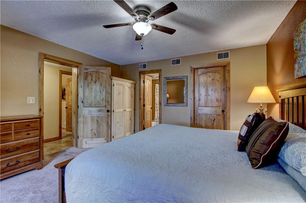 520 Bills Ranch Road, Unit 173 Frisco, CO 80443 - Photo 17 of 24 a spacious bedroom with a bed and a chandelier