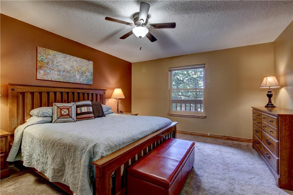 520 Bills Ranch Road, Unit 173 Frisco, CO 80443 - Photo 18 of 24 a bedroom with a bed and a chandelier