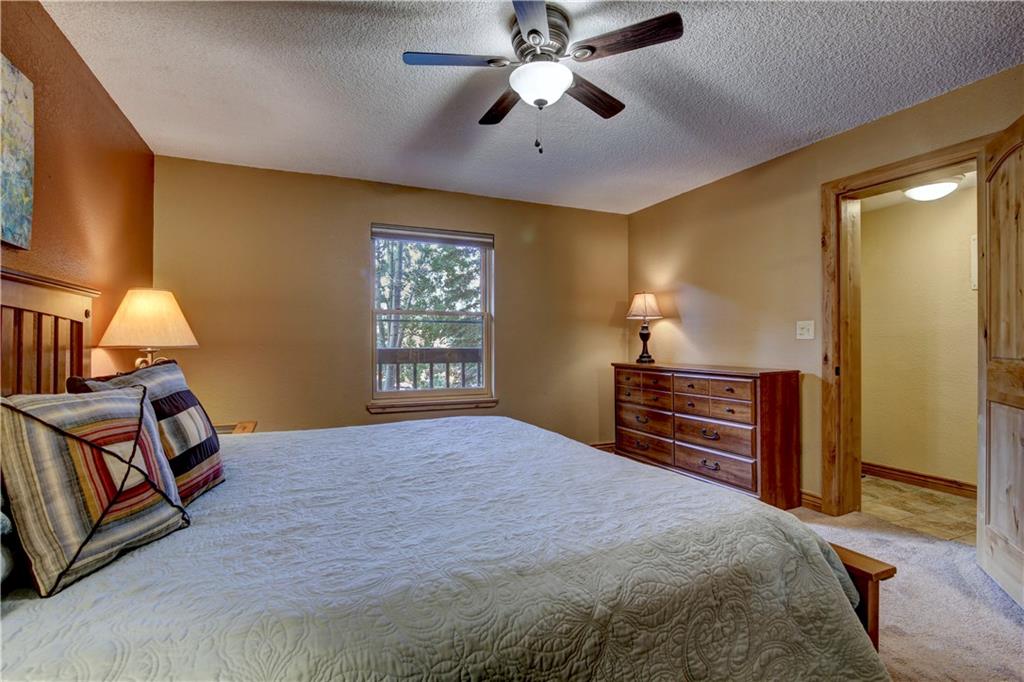 520 Bills Ranch Road, Unit 173 Frisco, CO 80443 - Photo 19 of 24 a bedroom with a bed and wooden floor
