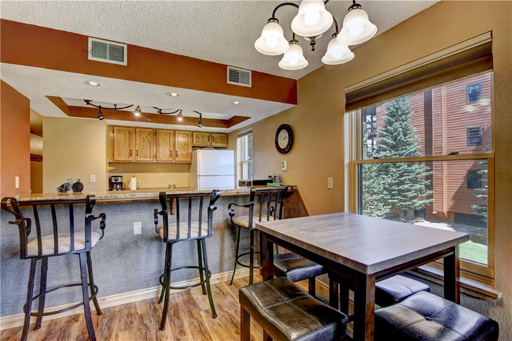 520 Bills Ranch Road, Unit 173 Frisco, CO 80443 - Photo 7 of 24 a view of a dining room with furniture and chandelier