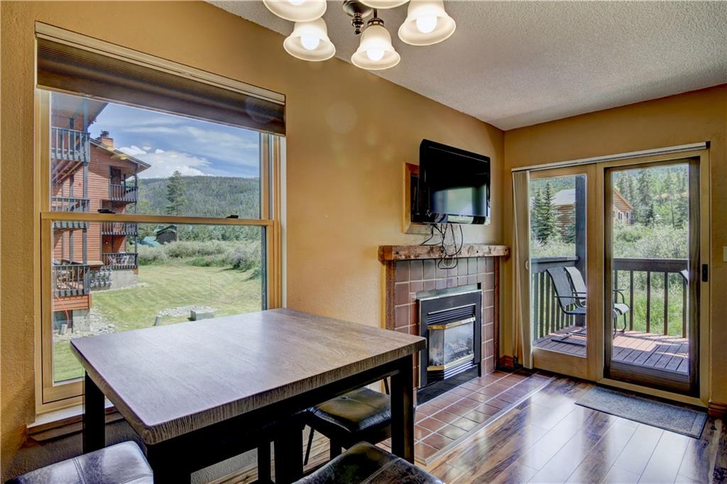 520 Bills Ranch Road, Unit 173 Frisco, CO 80443 - Photo 8 of 24 a view of a dining room with furniture window and wooden floor