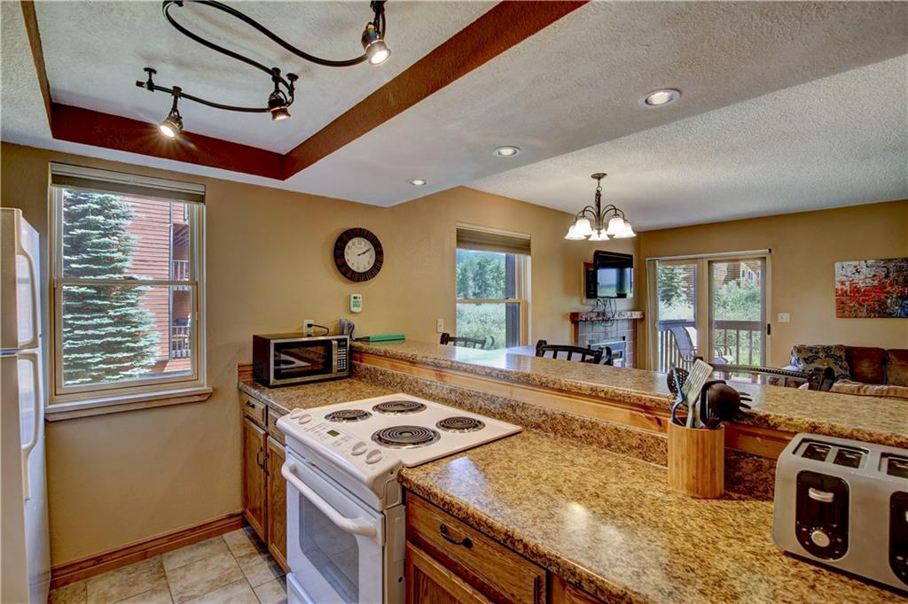 520 Bills Ranch Road, Unit 173 Frisco, CO 80443 - Photo 10 of 24 a kitchen that has a stove and a table