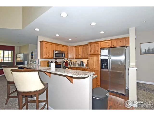 a kitchen with stainless steel appliances granite countertop a sink counter space and cabinets