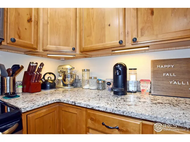 a bathroom with a granite countertop sink mirror vanity and toilet