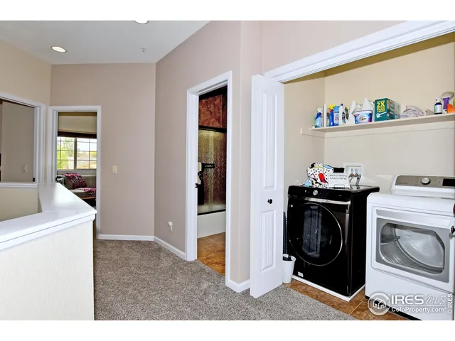 a view of a balcony with two chairs and a table