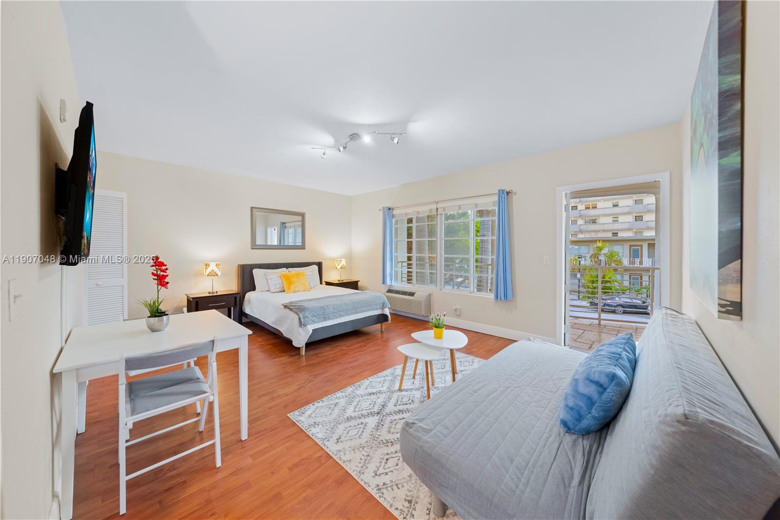 1241 14th Street, Unit 11 Miami Beach, FL 33139 - Photo 1 of 20 a bedroom with furniture and a flat screen tv