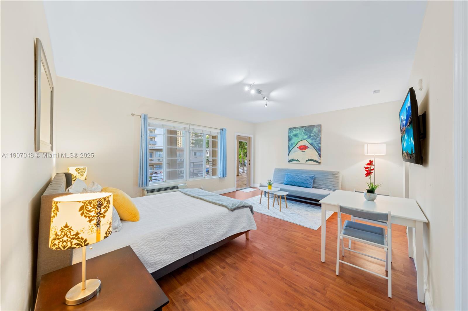 1241 14th Street, Unit 11 Miami Beach, FL 33139 - Photo 4 of 20 a bedroom with furniture and a wooden floor