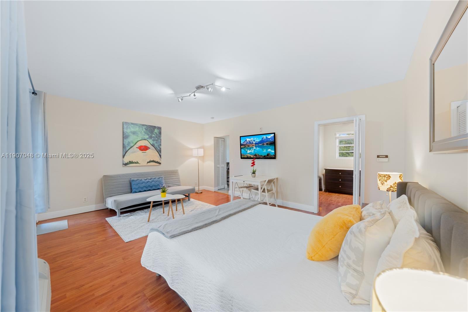 1241 14th Street, Unit 11 Miami Beach, FL 33139 - Photo 5 of 20 a living room with furniture and a flat screen tv