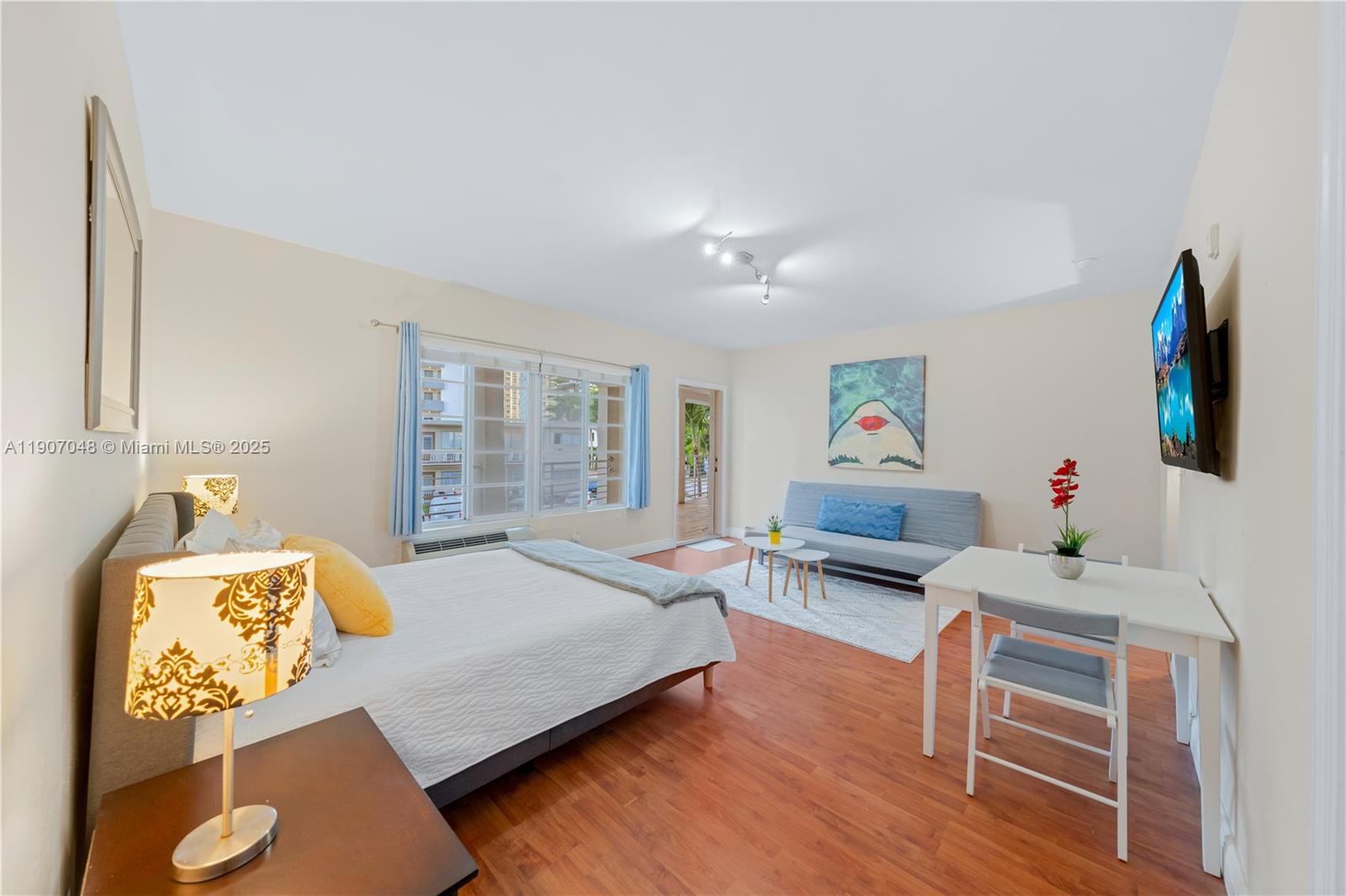 1241 14th Street, Unit 11 Miami Beach, FL 33139 - Photo 7 of 20 a bedroom with a bed and wooden floor