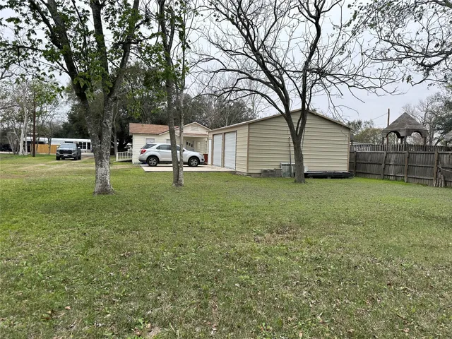 a view of a backyard with large trees