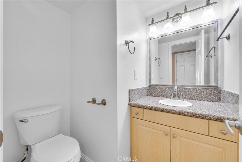 8083 Kerr Green Buena Park, CA 90621 - Photo 11 of 40 a bathroom with a granite countertop sink vanity mirror and toilet