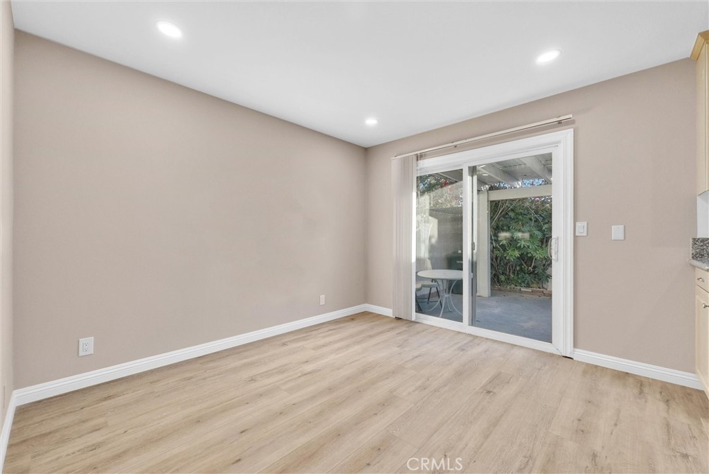 8083 Kerr Green Buena Park, CA 90621 - Photo 12 of 40 an empty room with wooden floor and windows