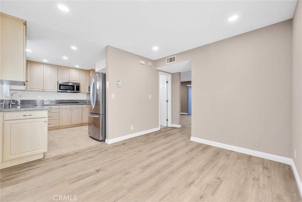 8083 Kerr Green Buena Park, CA 90621 - Photo 13 of 40 a kitchen with granite countertop white cabinets and stainless steel appliances