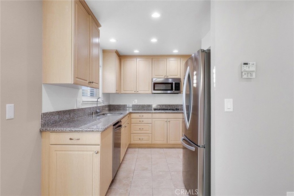 8083 Kerr Green Buena Park, CA 90621 - Photo 14 of 40 a kitchen with a sink stove and refrigerator