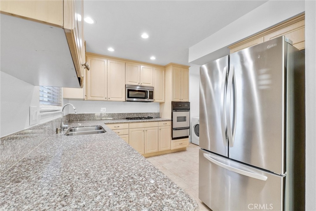 8083 Kerr Green Buena Park, CA 90621 - Photo 15 of 40 a kitchen with stainless steel appliances granite countertop a refrigerator a stove a sink and a refrigerator