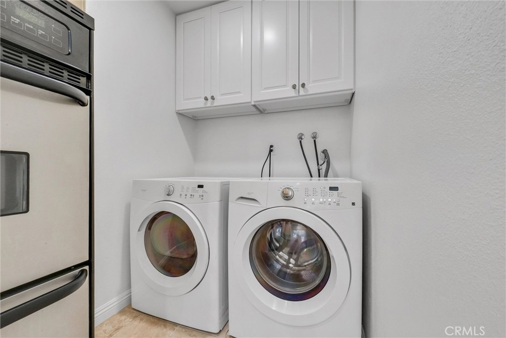 8083 Kerr Green Buena Park, CA 90621 - Photo 18 of 40 a view of washer and dryer with kitchen in the background